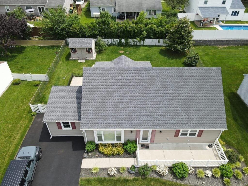 Aerial view of a home with a gray asphalt shingle roof, one of the most popular residential roof types.