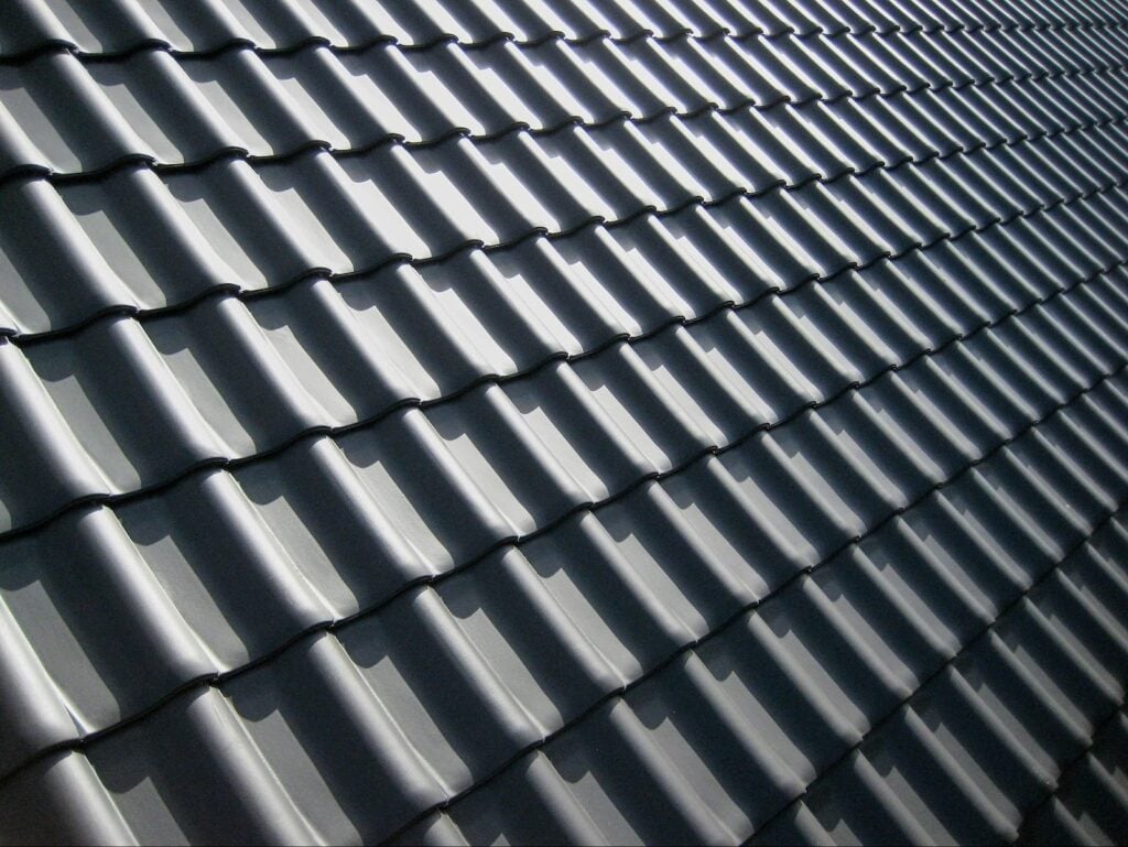 Close-up of reflective metal roof panels, showcasing an energy-efficient roofing option that helps reduce heat absorption.