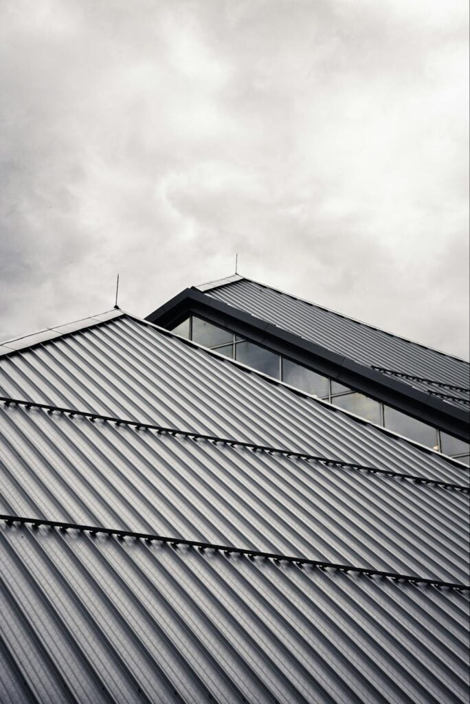 Metal roofing installed on a modern home, illustrating a durable and cost-effective roofing material option commonly used by contractors.
