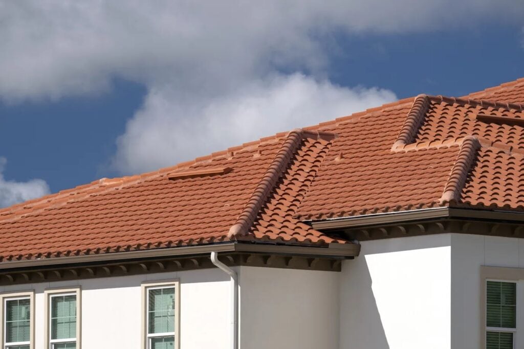 Well-maintained clay tile roof on a residential home, illustrating how regular maintenance and strong warranty coverage can help extend the lifespan of durable roofing materials. Well-maintained clay tile roof on a residential home, illustrating how regular maintenance and strong warranty coverage can help extend the lifespan of durable roofing materials.