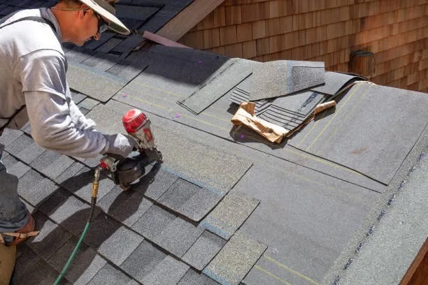 Roofer installing shingles on a sloped roof, highlighting durable roofing systems designed to perform well against Florida’s heat, rain, and storm conditions.
