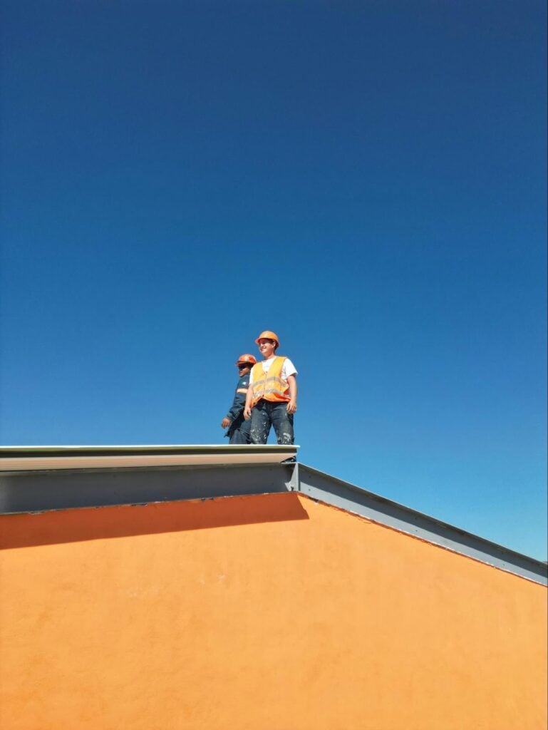 Roofing professionals inspecting a rooftop to identify potential problem areas, demonstrating how experts detect and diagnose roof leaks before they cause major damage.
