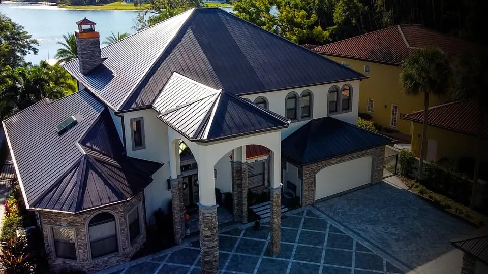 Large home with a durable metal roofing system, illustrating how professional roofing solutions can enhance property safety and long-term protection.